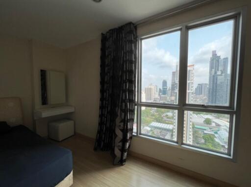 Modern bedroom with large window and city view