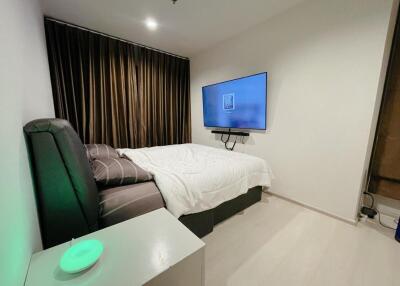 Modern bedroom with wall-mounted TV and a large bed