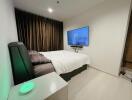 Modern bedroom with wall-mounted TV and a large bed