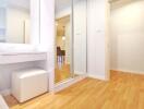 Bright hallway with hardwood floors and built-in dressing area