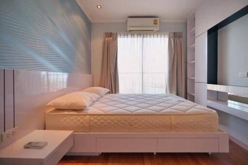 Modern bedroom with a large bed and window