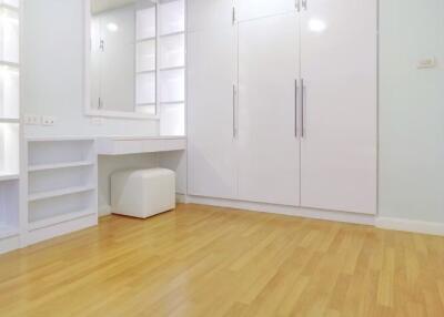 Modern bedroom with built-in wardrobe and vanity table