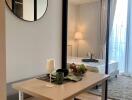 View of the bedroom through glass sliding doors with a small table in the foreground