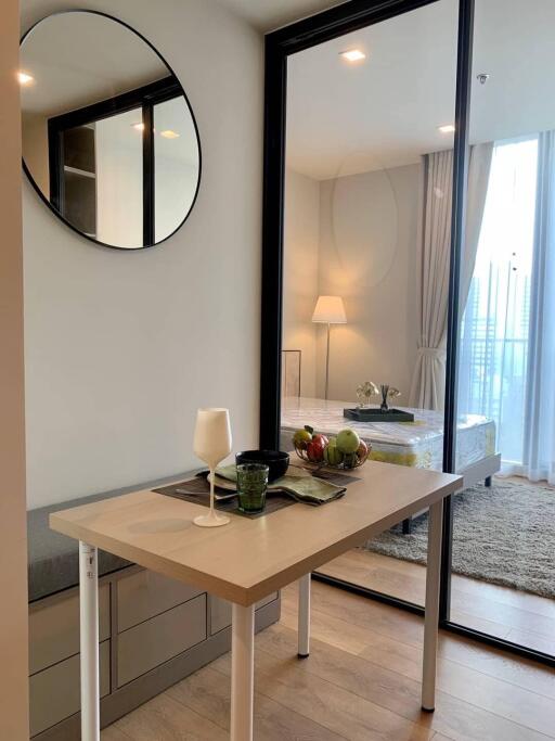 View of the bedroom through glass sliding doors with a small table in the foreground