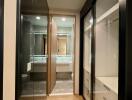 Modern walk-in closet leading to a bathroom with ample storage space