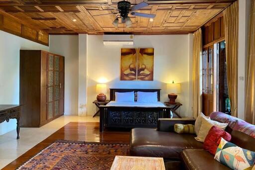 Spacious bedroom with wooden ceiling and modern amenities