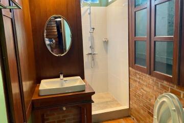 Bathroom with wooden accents and modern shower