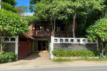 Front view of a residential house surrounded by trees