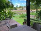 Outdoor patio with a view of a lake and greenery