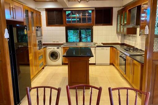 Spacious kitchen with wooden cabinets and modern appliances