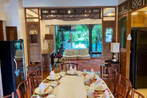 Elegant dining area with a view of the living space and outdoor garden