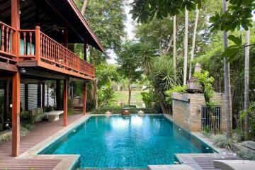 Beautiful outdoor pool area with lush greenery and seating