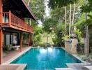 Beautiful outdoor pool area with lush greenery and seating