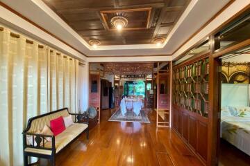 Spacious and elegant main living area with wooden flooring and traditional decor