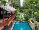 Outdoor area with a swimming pool and a covered wooden patio