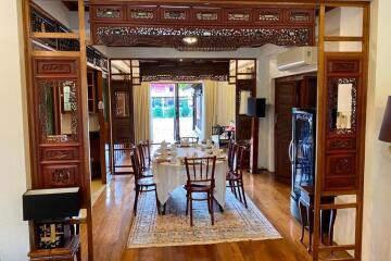 Spacious dining room with ornate wooden detailing and a dining table set for six