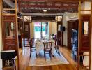 Spacious dining room with ornate wooden detailing and a dining table set for six