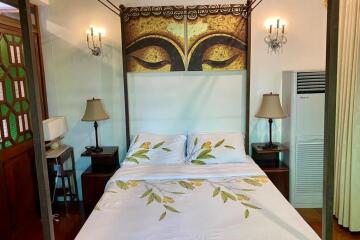 Cozy bedroom with a decorative canopy bed and elegant lighting fixtures