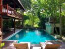 Spacious outdoor area with a swimming pool surrounded by greenery