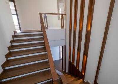 Modern staircase with wooden steps and decorative lighting