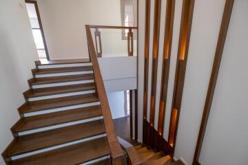 Modern staircase with wooden steps and decorative lighting