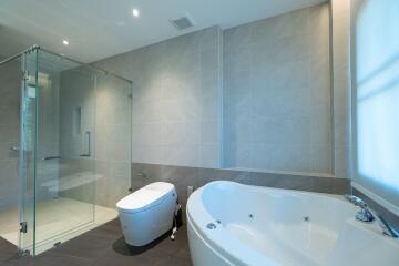 Modern bathroom with bathtub and glass shower