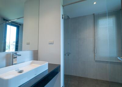 Modern bathroom with sink and glass-enclosed shower