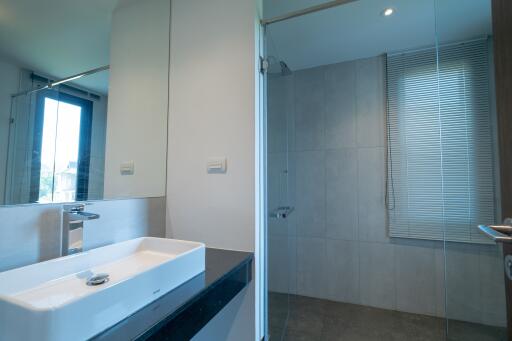 Modern bathroom with sink and glass-enclosed shower