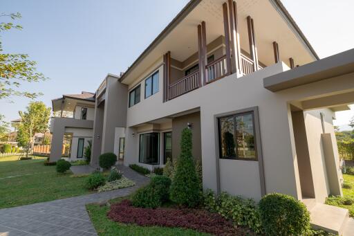 Exterior view of a modern two-story house with garden