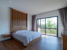 Spacious bedroom with large windows and a wooden accent wall