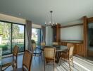 Spacious dining room with large windows and wooden chairs