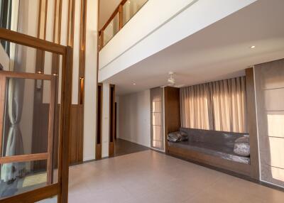 Spacious living room with high ceilings and large windows