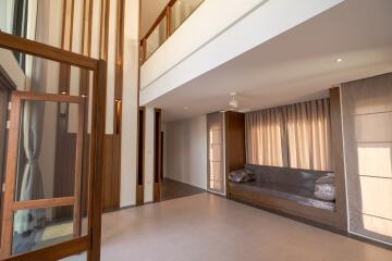 Spacious living room with high ceilings and large windows