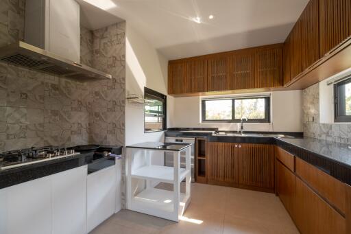 Modern kitchen with wooden cabinets and built-in appliances