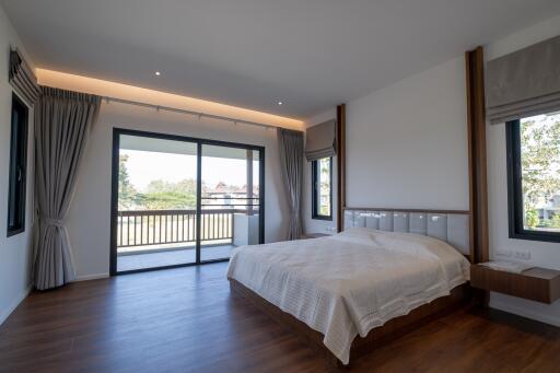 Modern bedroom with large windows and balcony