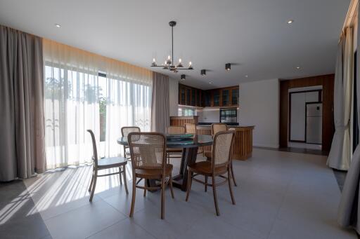 Modern open-plan kitchen and dining area with natural light