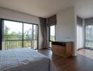 Modern bedroom with large windows and natural light