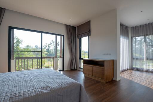 Modern bedroom with large windows and natural light