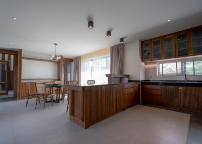 Spacious kitchen with wooden cabinets and adjacent dining area