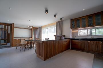 Spacious kitchen with wooden cabinets and adjacent dining area