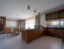 Spacious kitchen with wooden cabinets and adjacent dining area