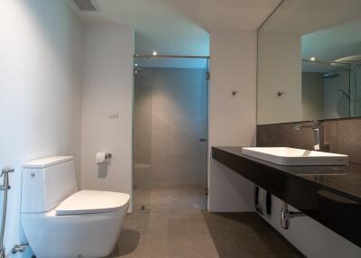 Modern and clean bathroom with toilet, sink, and shower