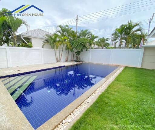 Outdoor swimming pool with surrounding greenery