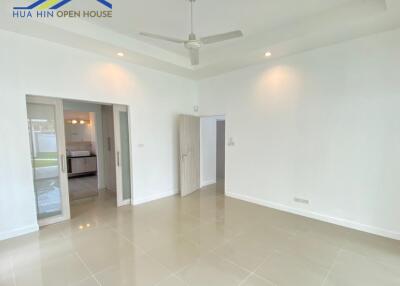 Living room with ceiling fan, tiled floor, and view of kitchen