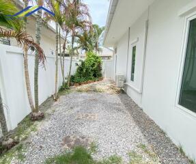 Side path with gravel and landscaping