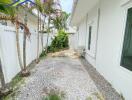 Side path with gravel and landscaping