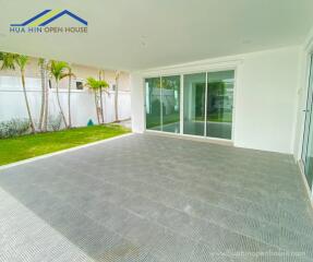 Covered patio with tiled flooring and garden view