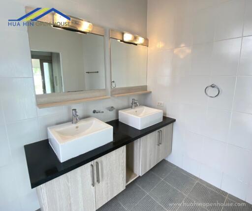 Modern bathroom with dual sinks and large mirrors