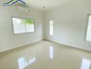 Bright and empty bedroom with large windows and white walls