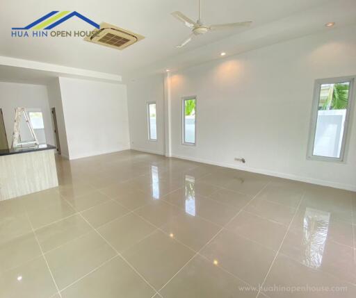 Spacious living room with modern tile flooring and ceiling fan